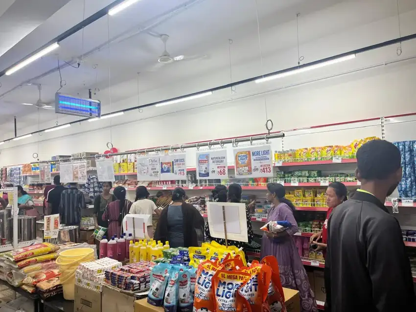 Customers browsing a busy Price Company store